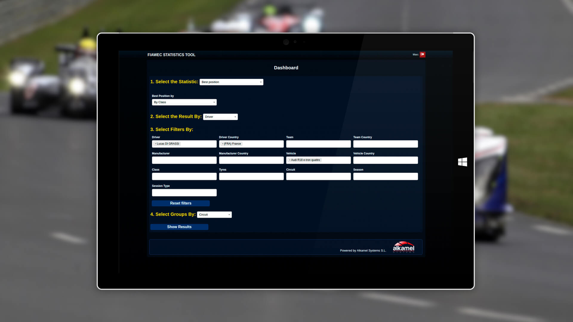 Tablet with Alkamel statistics with a car race like background image