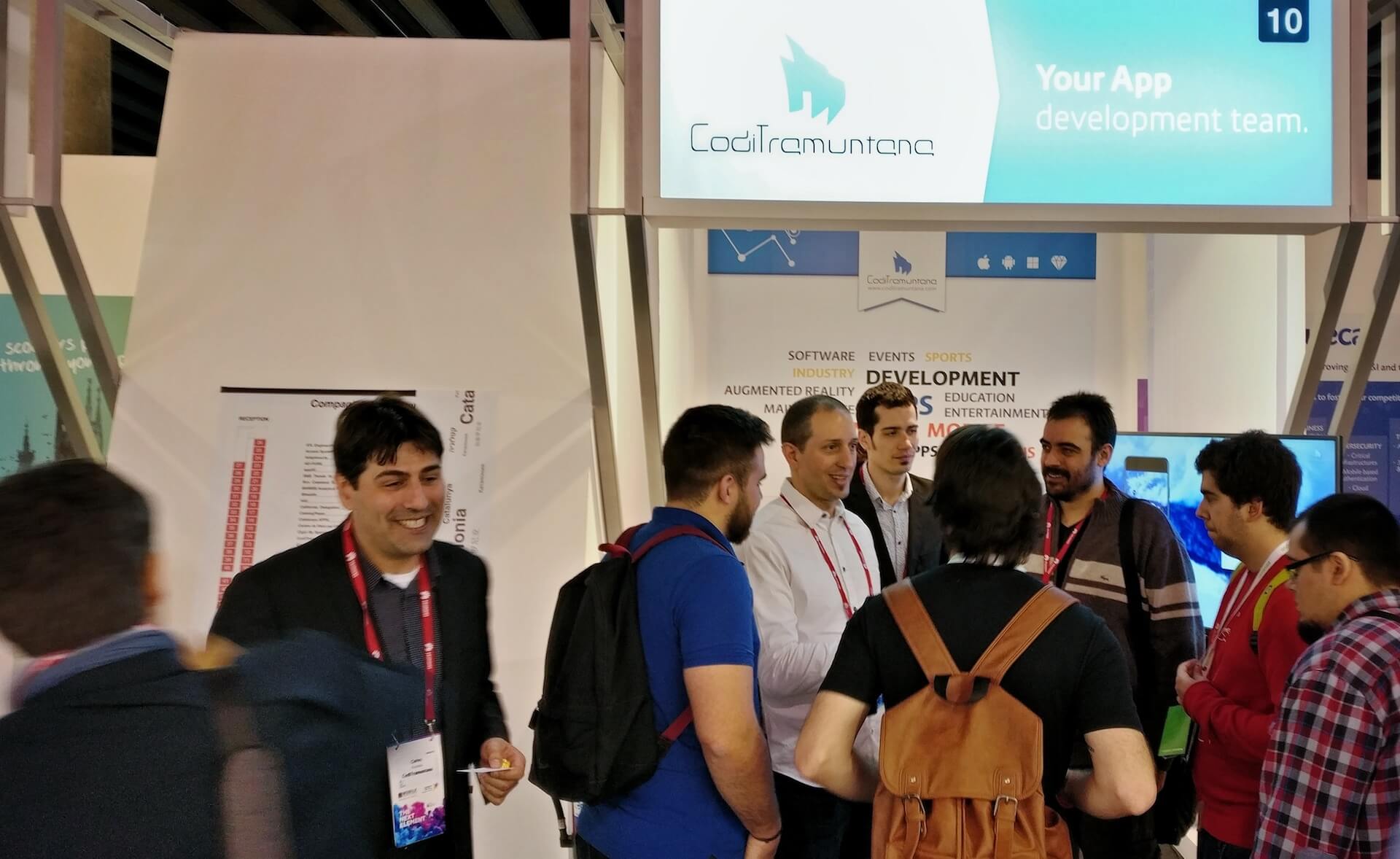 9 persons visiting the CodiTramuntana stand at MWC2017 of Barcelona